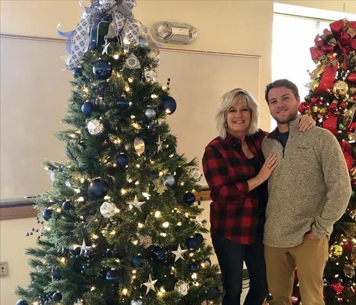 Dustin and Sherry next to decorated christmas tree