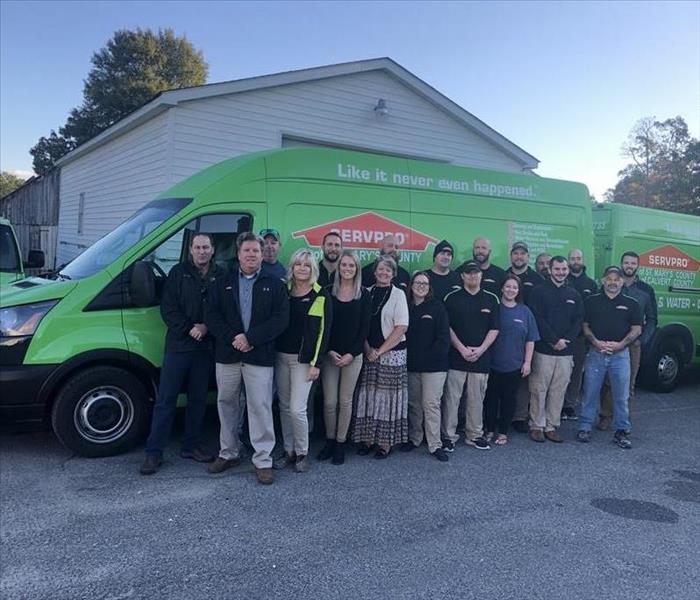 2019 SERVPRO crew standing behind one of our lime green SERVPRO vans