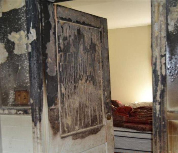 A closed door in a home showing the effects of stopping fire and smoke from entering. 