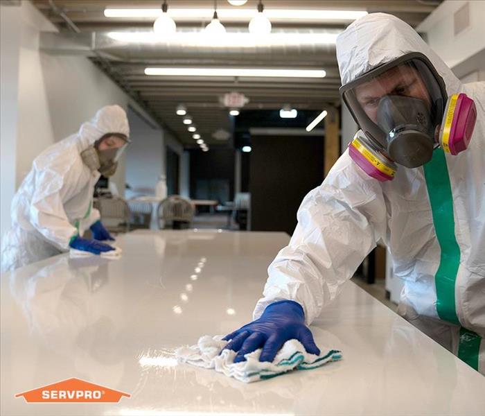 Employees in PPE providing a SERVPRO cleaning service